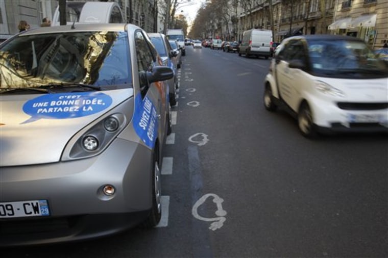In this photo taken Friday, Dec. 2, 2011, a parking station for the Autolib' electric car-share scheme is seen on a street in Paris. Autolib', a project built on the success of the city's bike-rental scheme, makes its debut Monday and officials want the self-service e-cars to be as much a part of Paris life as the Eiffel Tower or Notre Dame Cathedral. 